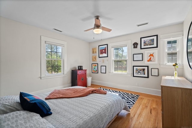 1748 Whitney Ave, Hamden, CT 06517 - bedroom featuring multiple windows, baseboards, wood-type flooring, and ceiling fan