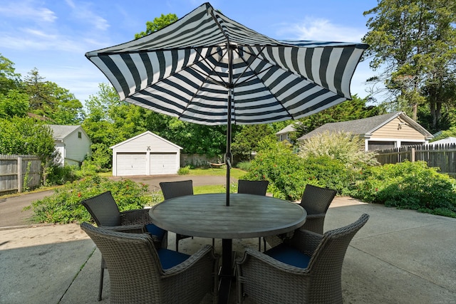 1748 Whitney Ave, Hamden, CT 06517 - view of patio with an outbuilding, outdoor dining space, and a detached garage