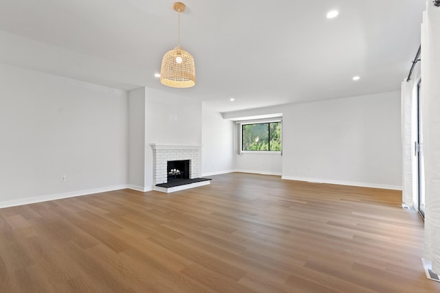156 Apache Ln Unit A, Stratford, CT 06614 - unfurnished living room with wood finished floors, recessed lighting, a fireplace, and baseboards