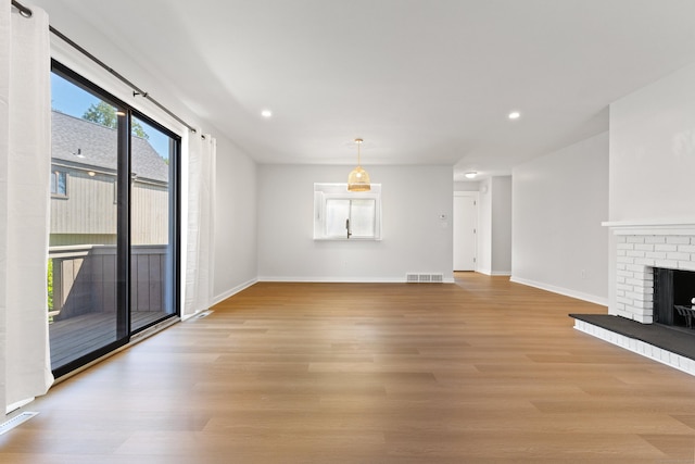 156 Apache Ln Unit A, Stratford, CT 06614 - unfurnished living room with light wood-style floors, baseboards, recessed lighting, and a brick fireplace