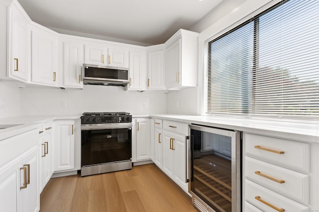 156 Apache Ln Unit A, Stratford, CT 06614 - kitchen with wine cooler, gas range, stainless steel microwave, and plenty of natural light