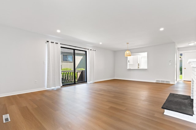 156 Apache Ln Unit A, Stratford, CT 06614 - unfurnished living room with light wood-style floors, baseboards, and recessed lighting