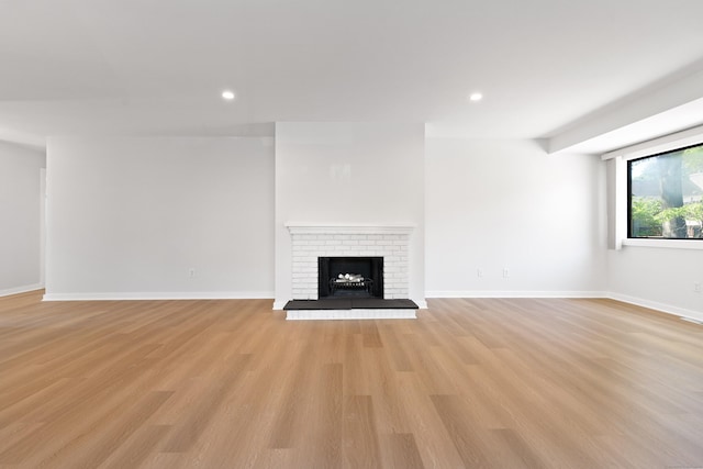 156 Apache Ln Unit A, Stratford, CT 06614 - unfurnished living room with light wood finished floors, a fireplace, recessed lighting, and baseboards