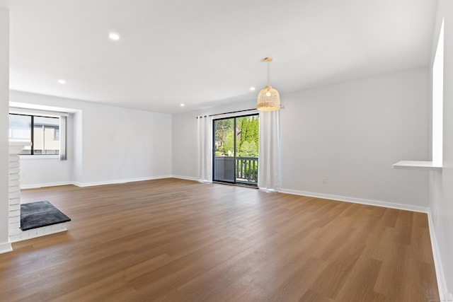156 Apache Ln Unit A, Stratford, CT 06614 - unfurnished living room featuring baseboards, wood finished floors, and recessed lighting