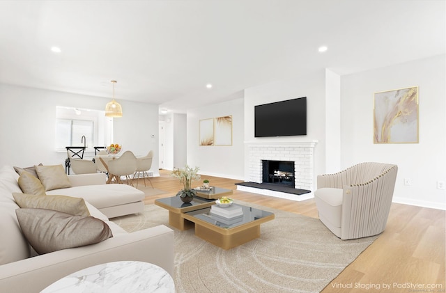 156 Apache Ln Unit A, Stratford, CT 06614 - living room with light wood-type flooring, baseboards, a brick fireplace, and recessed lighting