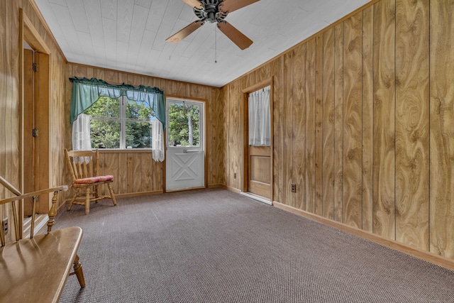 566 Beach Pond Rd, Voluntown, CT 06384 - unfurnished room with a ceiling fan, wood walls, and carpet floors