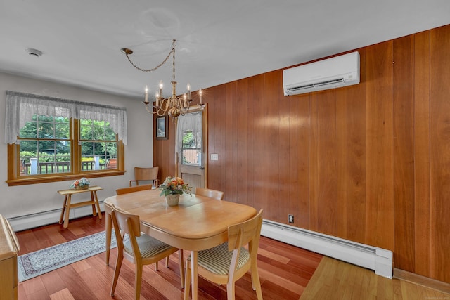 566 Beach Pond Rd, Voluntown, CT 06384 - dining space featuring a wall mounted air conditioner, a baseboard heating unit, a chandelier, wood finished floors, and wooden walls