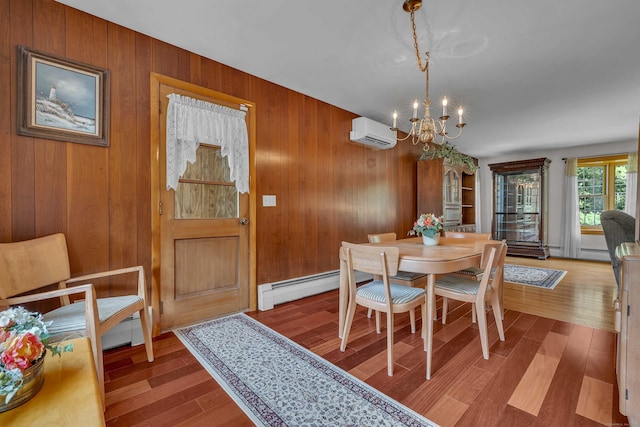 566 Beach Pond Rd, Voluntown, CT 06384 - dining space with an AC wall unit, a chandelier, wood finished floors, wood walls, and baseboard heating