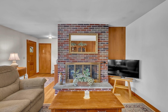 566 Beach Pond Rd, Voluntown, CT 06384 - living room featuring wood finished floors, a brick fireplace, a baseboard radiator, and baseboard heating