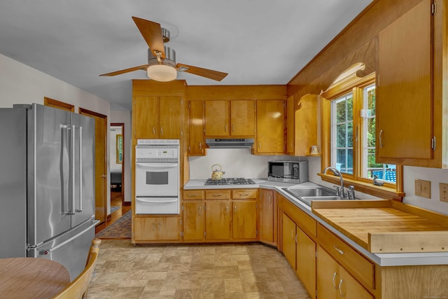 566 Beach Pond Rd, Voluntown, CT 06384 - kitchen with stainless steel appliances, a warming drawer, light countertops, under cabinet range hood, and a ceiling fan