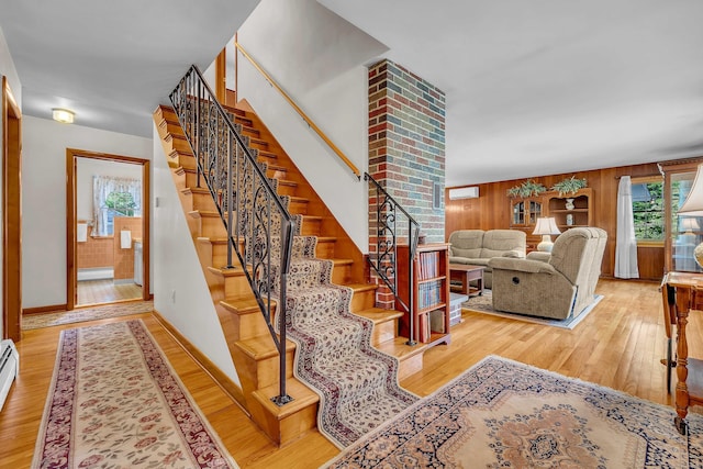 566 Beach Pond Rd, Voluntown, CT 06384 - stairway featuring wood finished floors, baseboard heating, and wood walls
