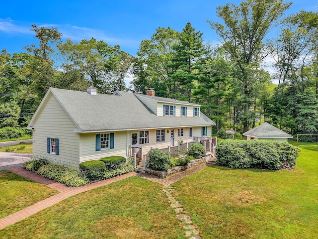 566 Beach Pond Rd, Voluntown, CT 06384 - view of front of house with a chimney, a shingled roof, a front lawn, a wooden deck, and view of wooded area