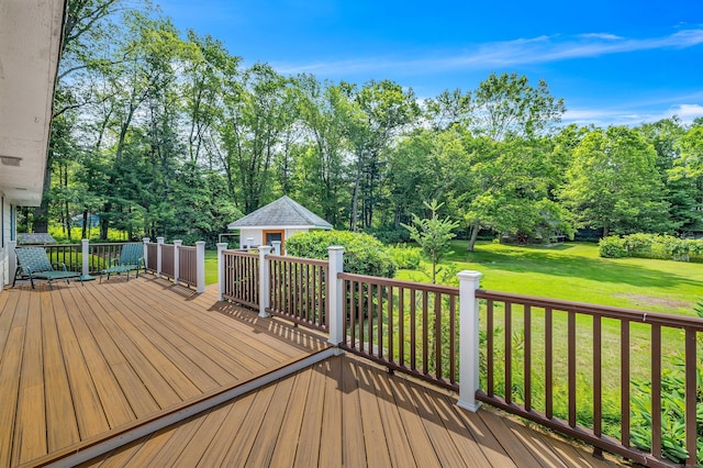 566 Beach Pond Rd, Voluntown, CT 06384 - wooden deck featuring a lawn, an outbuilding, and view of wooded area