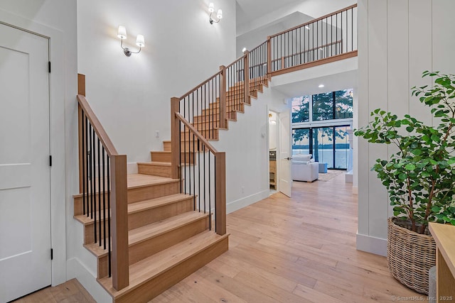 70 S Lake Shore Dr, Brookfield, CT 06804 - stairway featuring wood finished floors, a towering ceiling, and baseboards