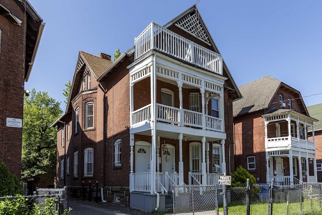 75 Madison St, Hartford, CT 06106 - view of front of home with a balcony, a fenced front yard, a porch, and brick siding