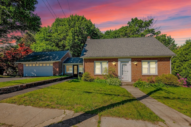 22 Hillside Ave, Torrington, CT 06790 - view of front of house with brick siding, a garage, and a front yard