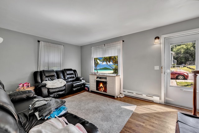 22 Hillside Ave, Torrington, CT 06790 - living area featuring a baseboard radiator, wood finished floors, and a lit fireplace