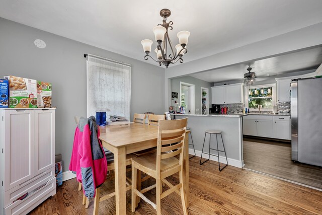 22 Hillside Ave, Torrington, CT 06790 - dining area featuring a chandelier, a ceiling fan, and wood finished floors