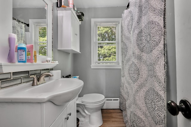 22 Hillside Ave, Torrington, CT 06790 - full bath featuring baseboard heating, healthy amount of natural light, vanity, and toilet