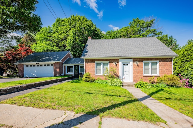 22 Hillside Ave, Torrington, CT 06790 - new england style home featuring brick siding, a front lawn, a chimney, and asphalt driveway