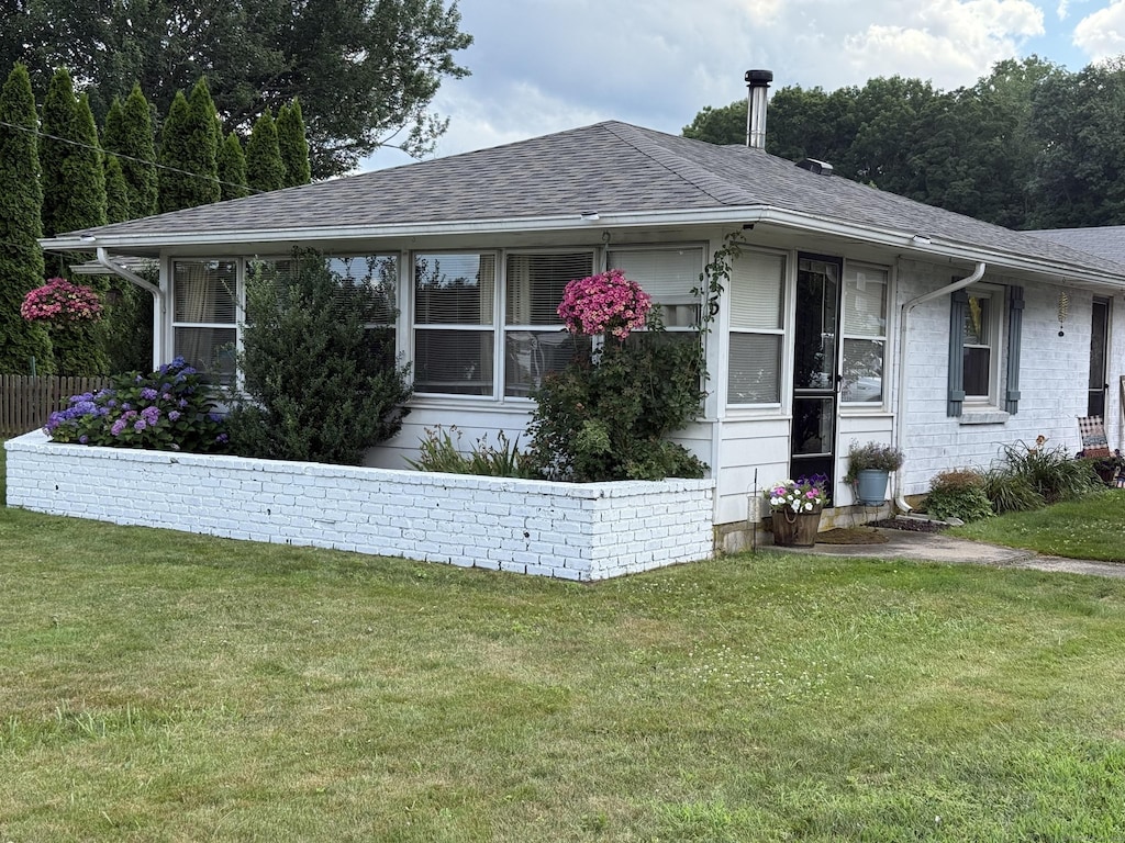 115 Paddock Ave, Meriden, CT 06450 - view of front of home featuring a front lawn, a shingled roof, and a sunroom