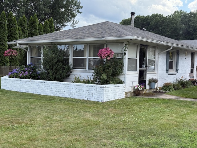 115 Paddock Ave, Meriden, CT 06450 - view of front of home featuring a front lawn, a shingled roof, and a sunroom