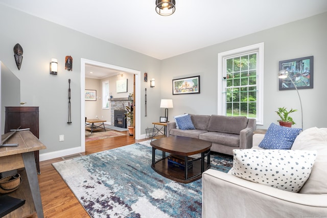 133 Hoop Pole Hill Rd, Woodbury, CT 06798 - living room featuring wood finished floors, baseboards, and a stone fireplace
