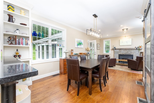 133 Hoop Pole Hill Rd, Woodbury, CT 06798 - dining room featuring crown molding, baseboards, a fireplace, and light wood-style floors
