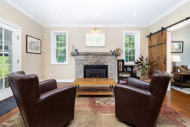 133 Hoop Pole Hill Rd, Woodbury, CT 06798 - living area featuring wood finished floors, crown molding, plenty of natural light, a barn door, and a fireplace