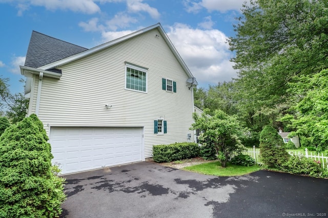 10 Deer Park Rd, Danbury, CT 06811 - view of home's exterior with driveway, roof with shingles, and an attached garage