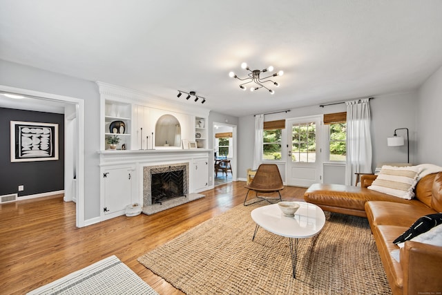 126 Newfield St, Middletown, CT 06457 - living area featuring light wood-type flooring, a chandelier, a high end fireplace, and baseboards