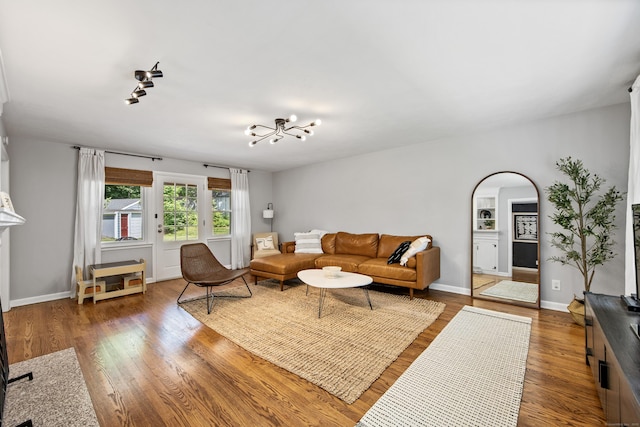 126 Newfield St, Middletown, CT 06457 - living room with wood finished floors, arched walkways, track lighting, baseboards, and a chandelier