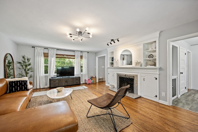 126 Newfield St, Middletown, CT 06457 - living area featuring light wood-type flooring, a premium fireplace, and a chandelier