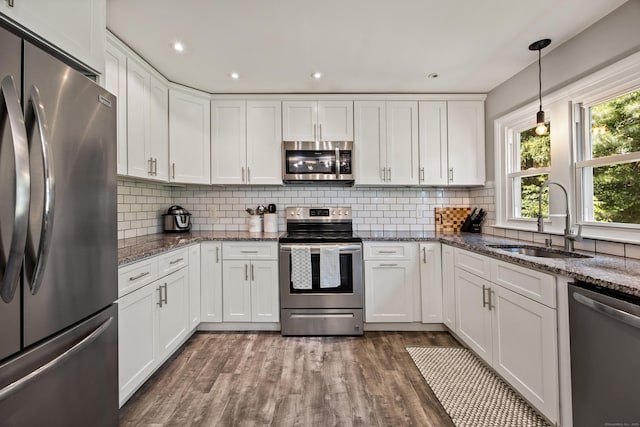 126 Newfield St, Middletown, CT 06457 - kitchen with stainless steel appliances, a sink, white cabinetry, wood finished floors, and recessed lighting
