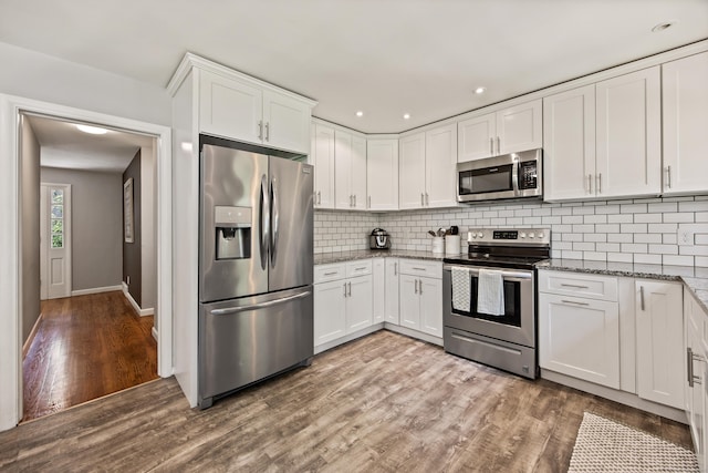 126 Newfield St, Middletown, CT 06457 - kitchen with stainless steel appliances, stone counters, wood finished floors, white cabinetry, and decorative backsplash