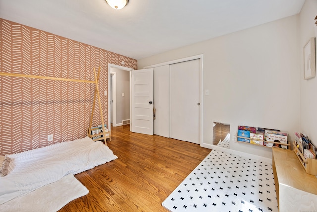 126 Newfield St, Middletown, CT 06457 - bedroom with wallpapered walls, wood finished floors, baseboards, and a closet