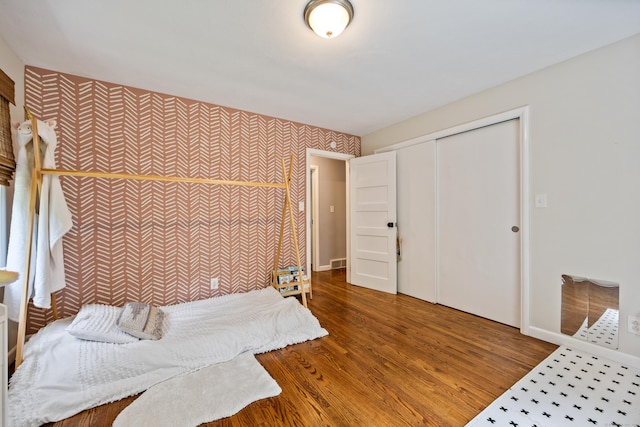 126 Newfield St, Middletown, CT 06457 - bedroom featuring wood finished floors, baseboards, wallpapered walls, and a closet