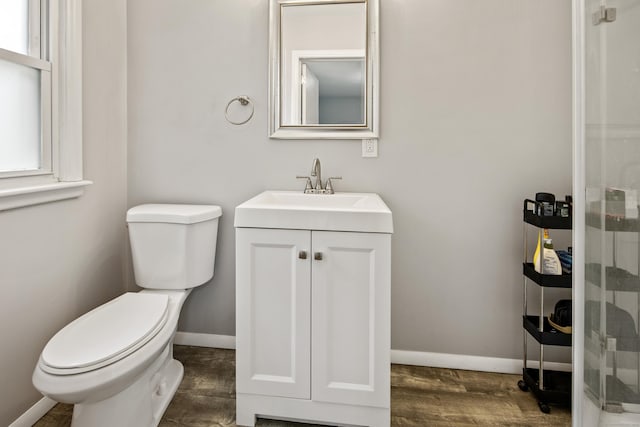 126 Newfield St, Middletown, CT 06457 - bathroom featuring vanity, toilet, wood finished floors, and baseboards