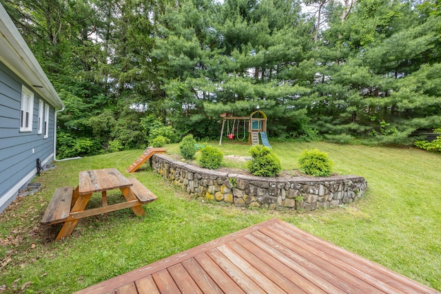 126 Newfield St, Middletown, CT 06457 - view of green lawn featuring a playground, a deck, and view of scattered trees