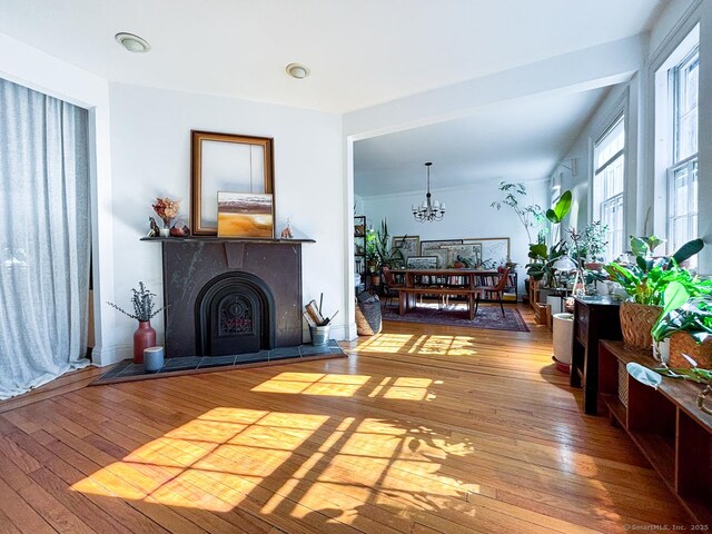 492 Whitney Ave Unit 4B, New Haven, CT 06511 - living area with hardwood / wood-style floors, a fireplace with raised hearth, and a chandelier