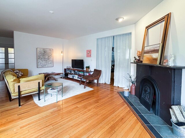 492 Whitney Ave Unit 4B, New Haven, CT 06511 - living room featuring wood-type flooring and a tile fireplace