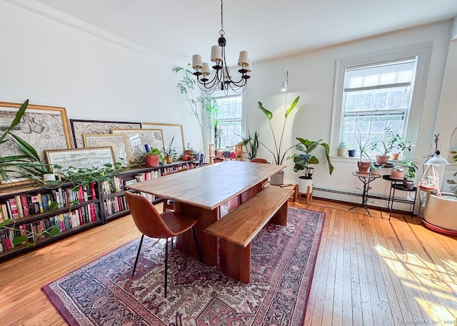 492 Whitney Ave Unit 4B, New Haven, CT 06511 - dining area with a baseboard radiator, a chandelier, and wood-type flooring