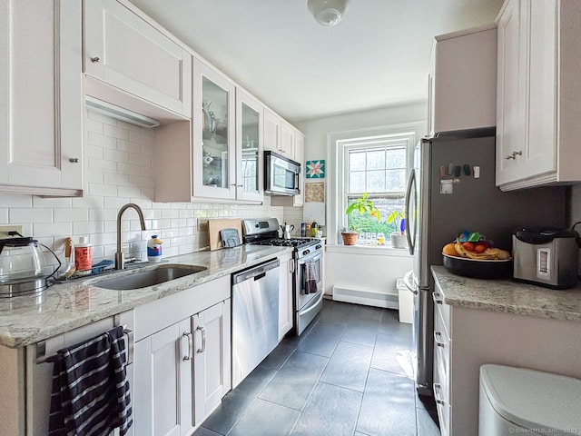 492 Whitney Ave Unit 4B, New Haven, CT 06511 - kitchen with stainless steel appliances, a sink, decorative backsplash, glass insert cabinets, and light stone countertops