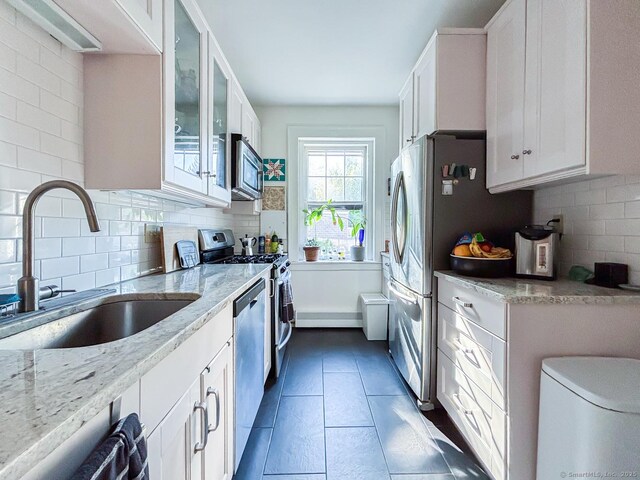 492 Whitney Ave Unit 4B, New Haven, CT 06511 - kitchen with a sink, stainless steel appliances, light stone counters, white cabinetry, and backsplash
