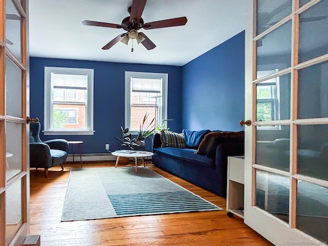 492 Whitney Ave Unit 4B, New Haven, CT 06511 - living area with a baseboard radiator, healthy amount of natural light, and wood finished floors