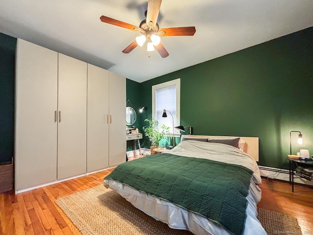 492 Whitney Ave Unit 4B, New Haven, CT 06511 - bedroom with light wood-style floors, a baseboard heating unit, and ceiling fan