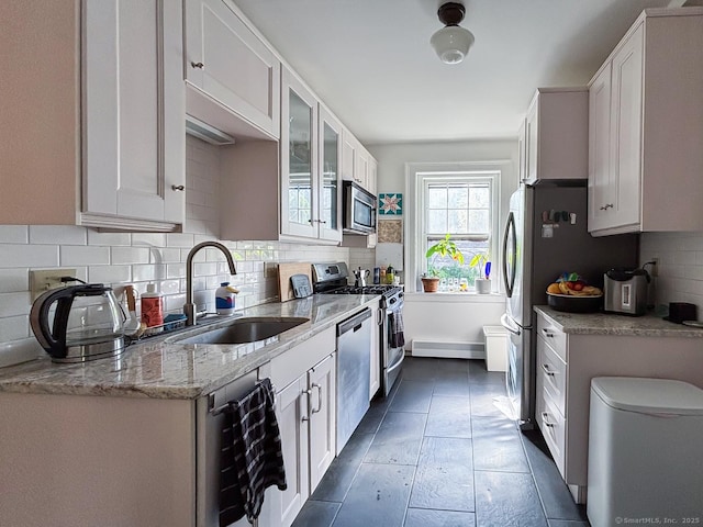 492 Whitney Ave Unit 4B, New Haven, CT 06511 - kitchen featuring a sink, appliances with stainless steel finishes, tasteful backsplash, white cabinetry, and light stone countertops