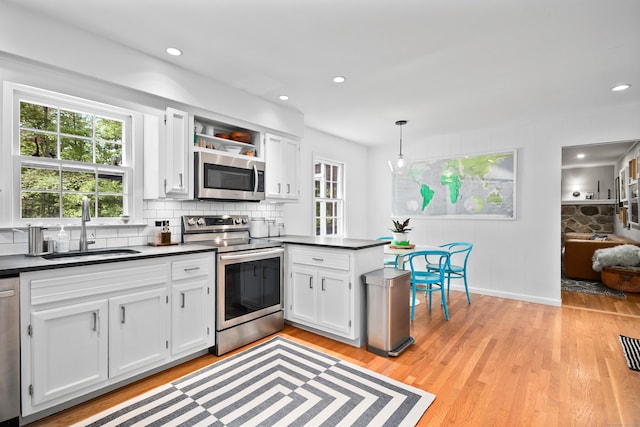 68 Blue Spruce Cir, Weston, CT 06883 - kitchen with stainless steel appliances, a sink, dark countertops, white cabinets, and recessed lighting