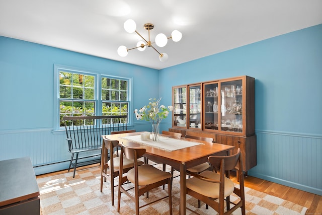 68 Blue Spruce Cir, Weston, CT 06883 - dining space featuring a wainscoted wall, a baseboard radiator, a chandelier, and light wood-type flooring