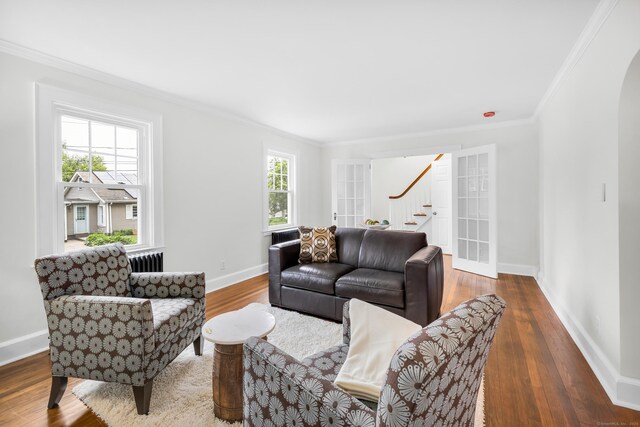 8 Wild Rose Pl, Waterford, CT 06385 - living area with stairs, crown molding, wood finished floors, baseboards, and radiator